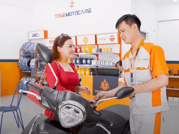 Thợ sửa xe của True Moto Care tư vấn thay thế phụ tùng xe máy cho khách hàng trước khi tiến hành sửa chữa